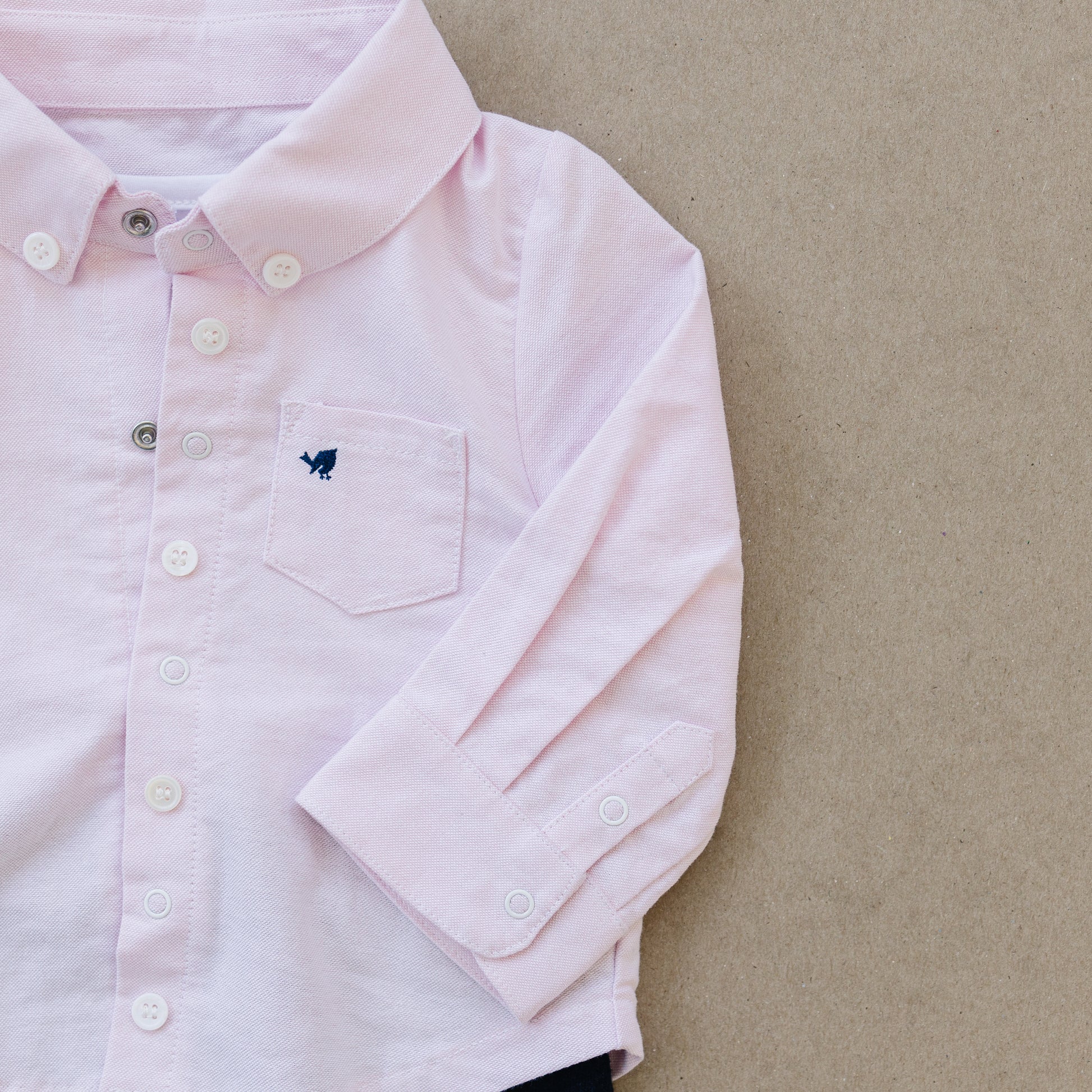 Preppy pink baby oxford shirt made by London Lark. Baby outfit is made from cotton with bamboo onesie underneath.