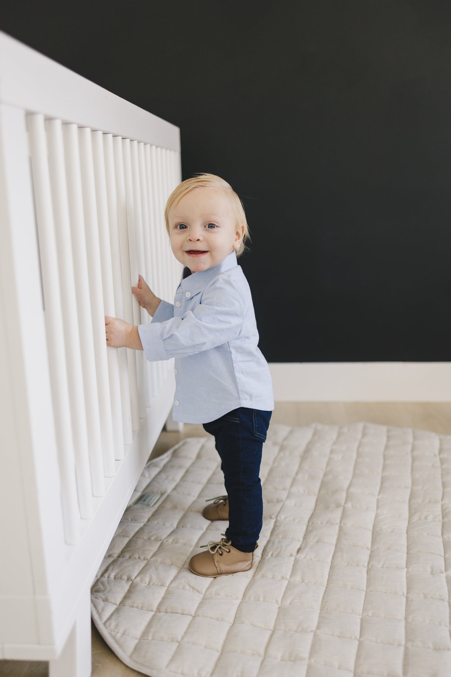 Baby wearing long sleeved dress clothes with a blue oxford shirt. Perfect as a baby boy easter outfit or for photoshoots.