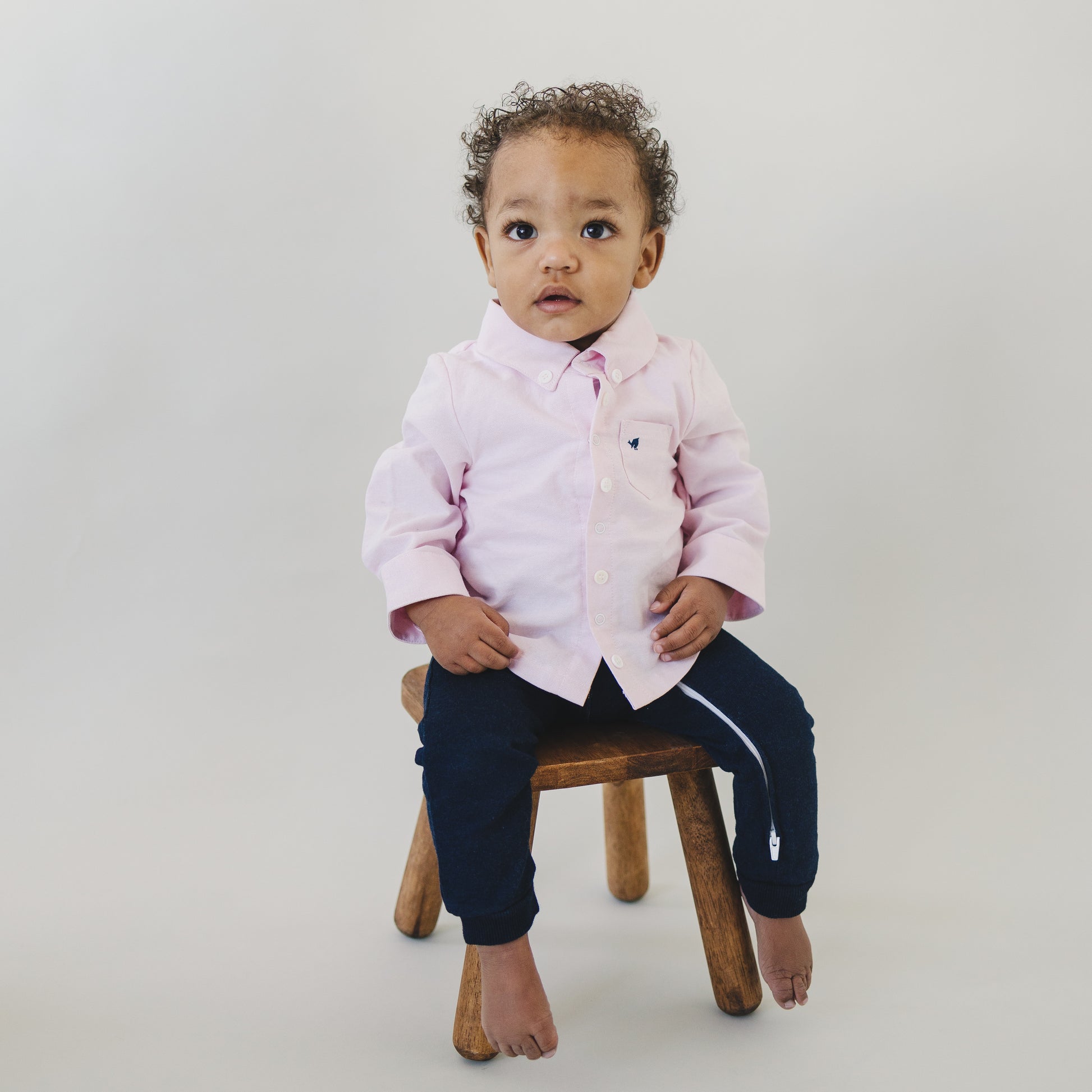 Baby boy dressy outfit made by London Lark with cute oxford shirt and stretchy denim pants included as a single onesie.