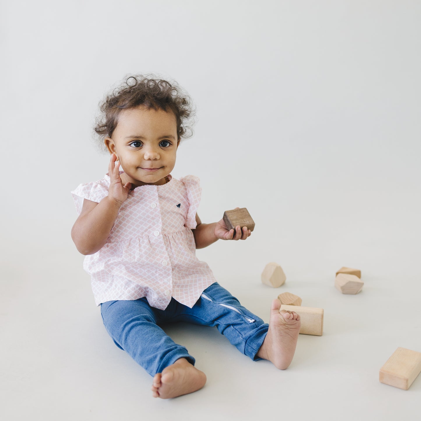 Happy baby girl wearing adorable shell print baby top. Outfit includes stretchy denim pants and comes in size 3 6 month.