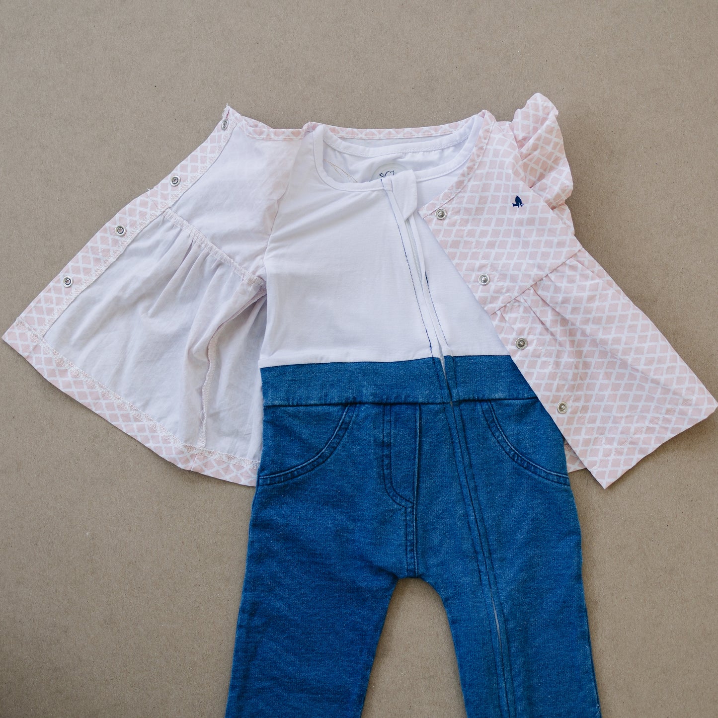 Stylish baby girls outfit showing how easy it is to unsnap and unzip this outfit. Diaper changes are easier with this design.